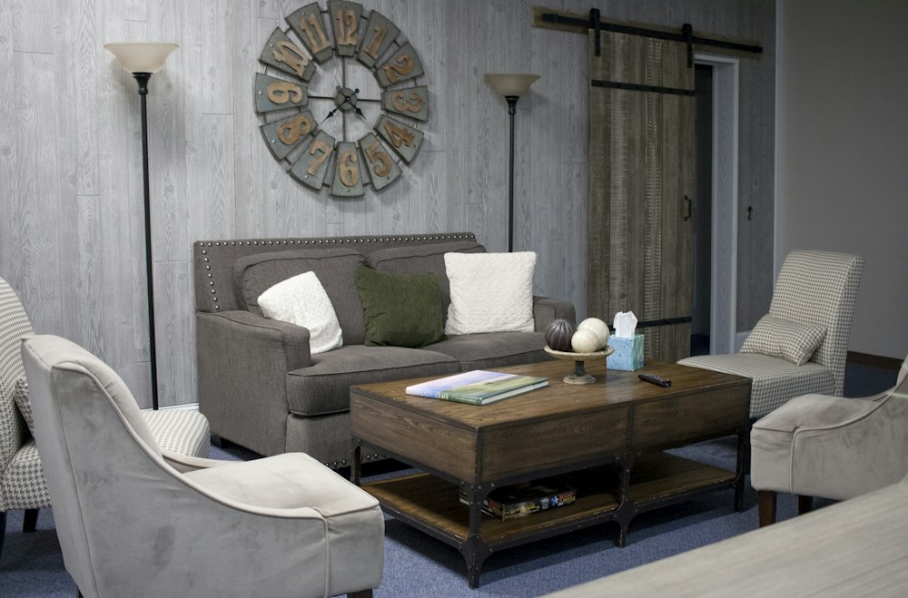 Sala de estar con sofá gris en su comuna